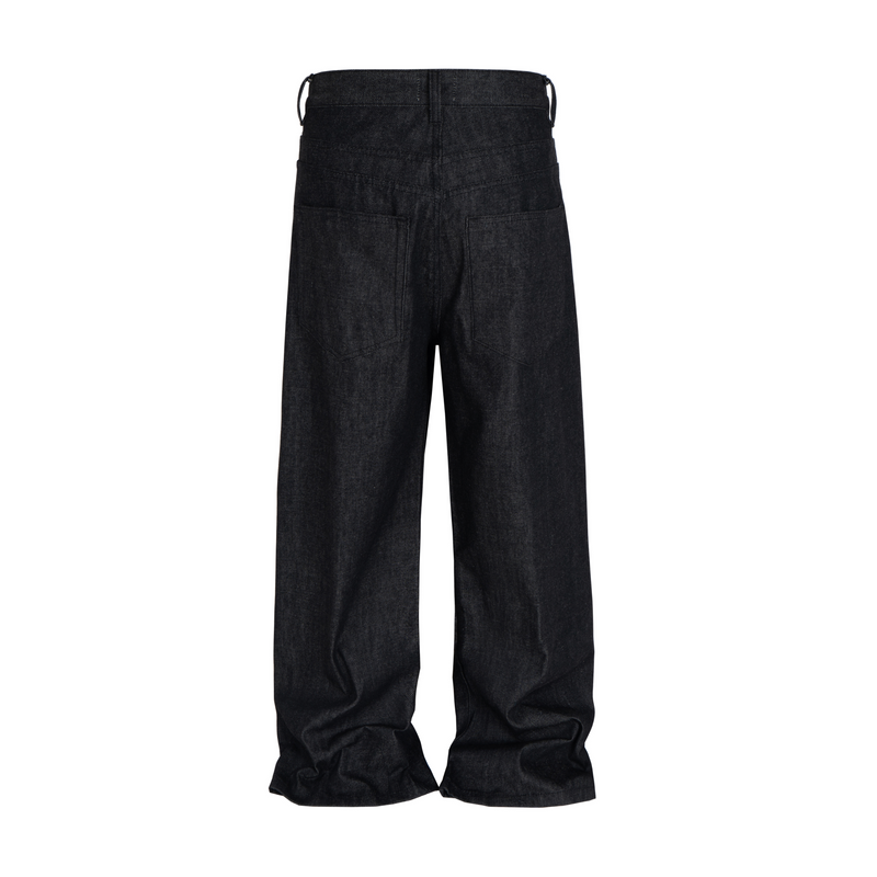 Black raw straight jeans shown from the back with stacked hems and wide legs