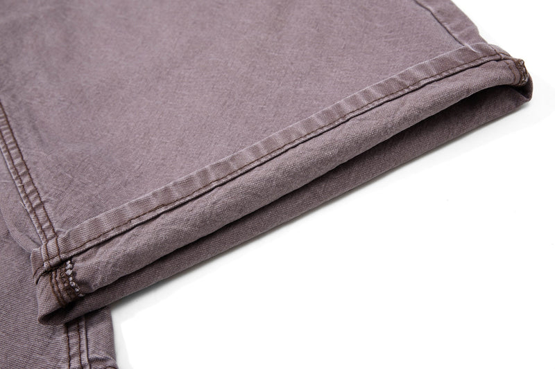 Close-up of folded brown denim hem and stitching