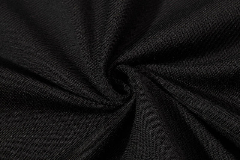 Black distressed polo shirt fabric with a textured knit and close-up folded detail