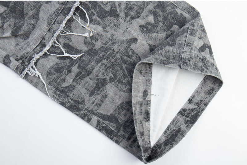 Close-up of gray camo pants hem with frayed edge and cuff opening