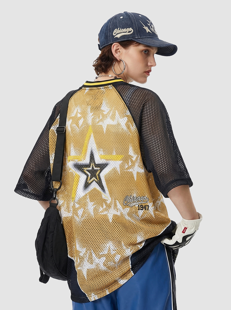 Black mesh jersey T-shirt with gold star graphic and Chicago print, styled on a model with cap and crossbody bag