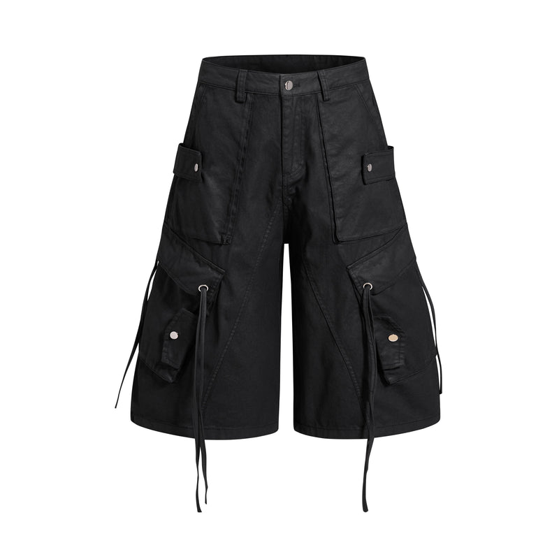 Black oversized cargo shorts with wide legs, front view, utility flap pockets and drawstring details