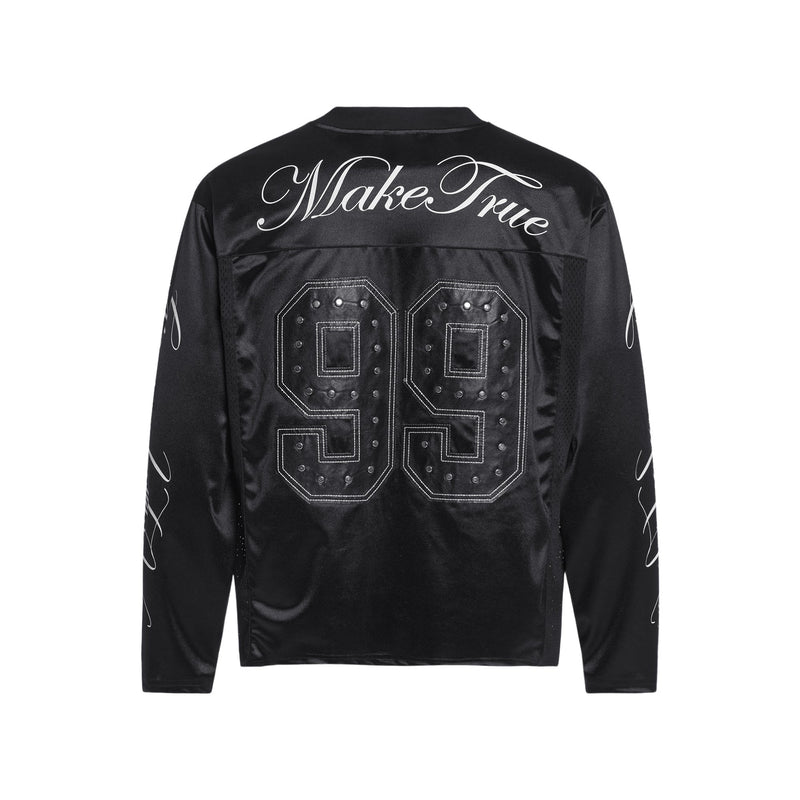 Back of black varsity jersey with large studded 99 graphic and Make True script across shoulders