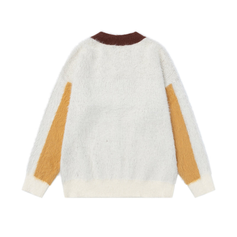 Back view of white fuzzy knit sweater with brown collar, yellow side panels, and ribbed hem