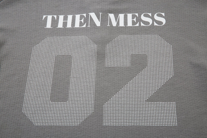 Close-up of gray shirt back with THEN MESS text above the large 02 print