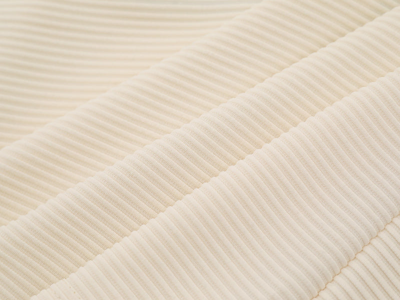 Close-up of cream jersey ribbed knit texture