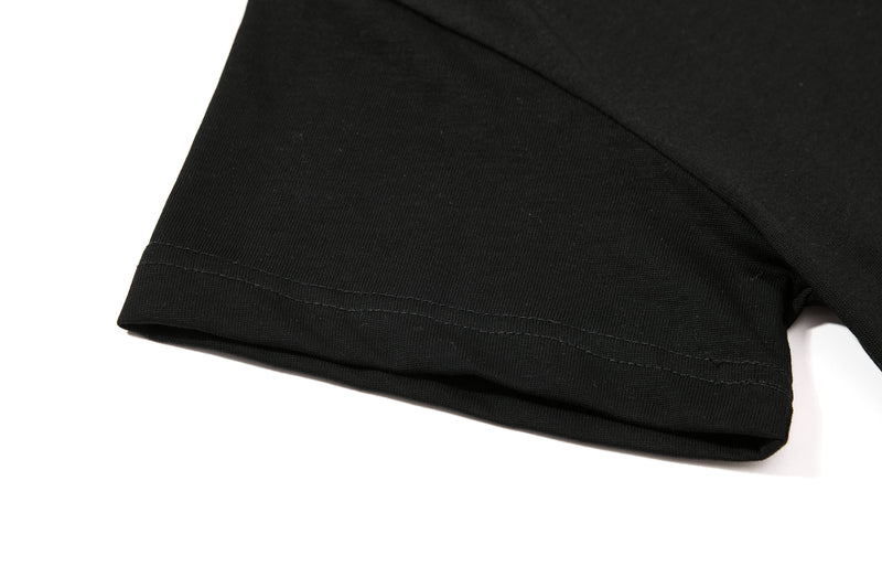 Close-up of black cotton polo tee sleeve hem with neat stitching and clean streetwear finish