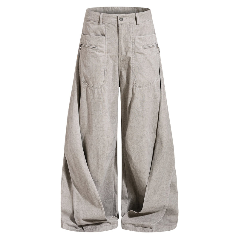Light beige washed denim jeans front view with wide legs and cargo-style zipper pockets