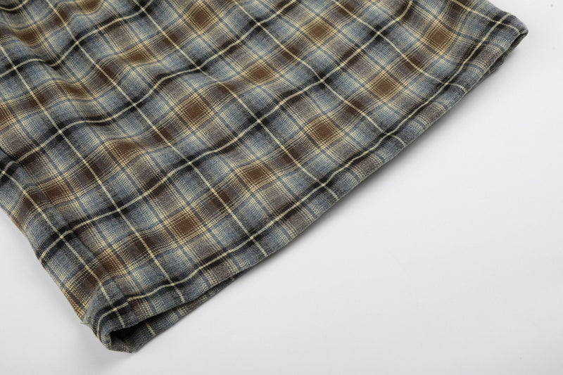 Close-up of hemmed leg opening on plaid lounge shorts