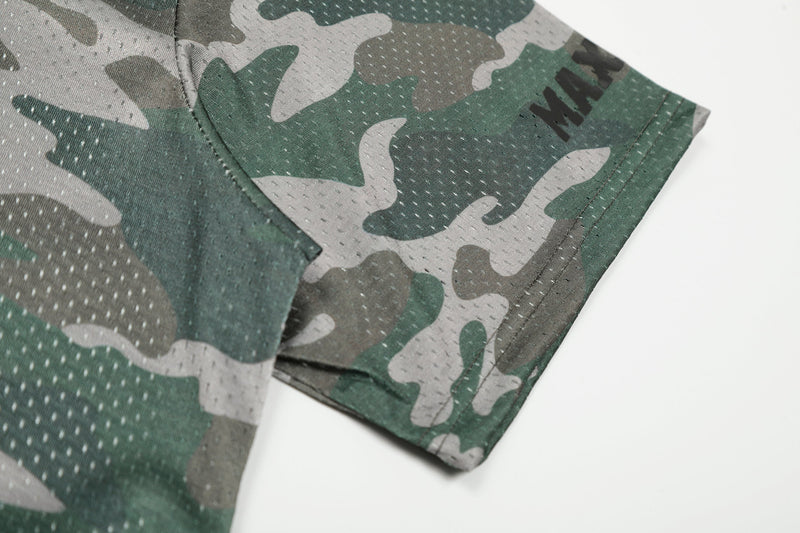 Close-up of green camo mesh jersey sleeve with stitched hem and perforated athletic fabric texture