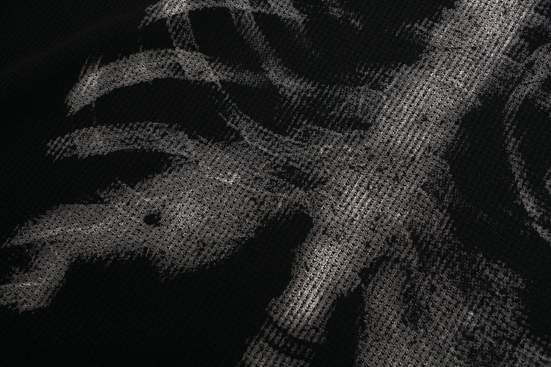 Close-up of black tee front print with ribcage and shoulder x-ray graphic