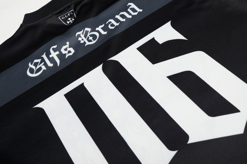 Black gothic mesh jersey with oversized white print and dark streetwear branding on the chest
