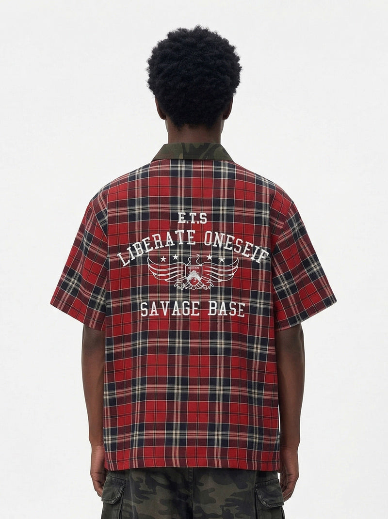Back view of a red plaid shirt with camo collar and bold Savage Base graphic on the back
