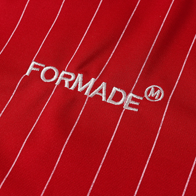 Red pinstripe soccer jersey fabric with embroidered FORMADE logo on textured performance material