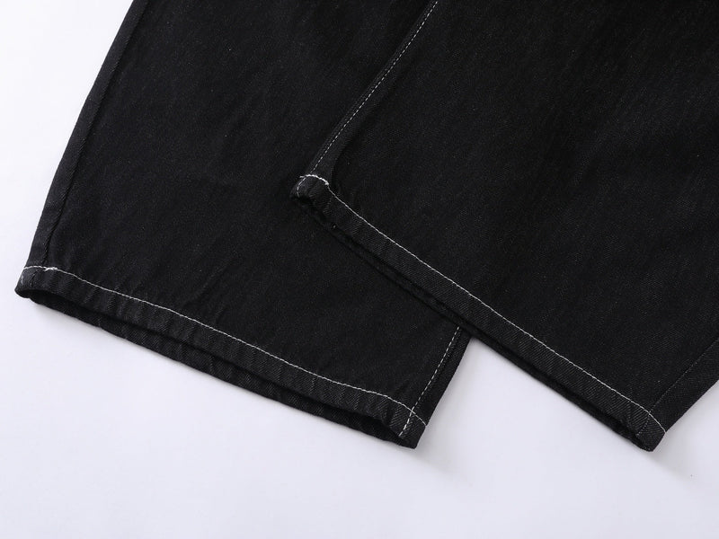Close-up of black denim hem with white contrast stitching