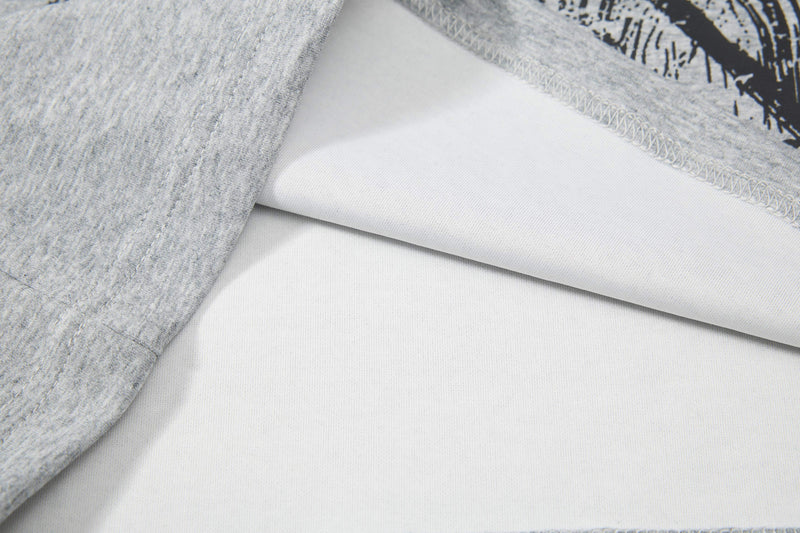 Close-up of a gray graphic polo tee showing white inner fabric and stitched hem details with medieval print accents