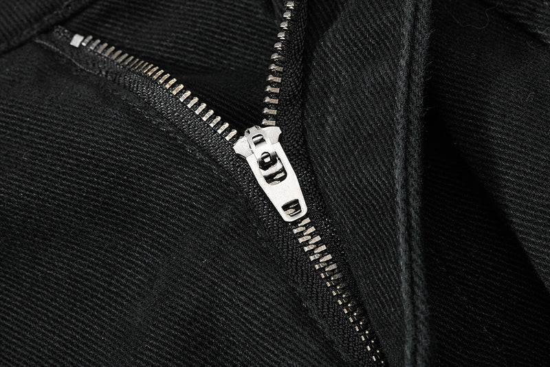 Close-up of black pants zipper closure with silver zipper pull