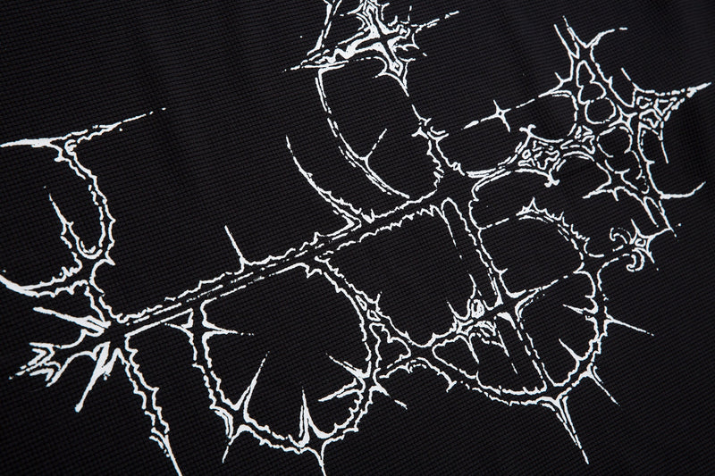 Black gothic polo shirt with cracked white thorn cross graphic print on textured fabric