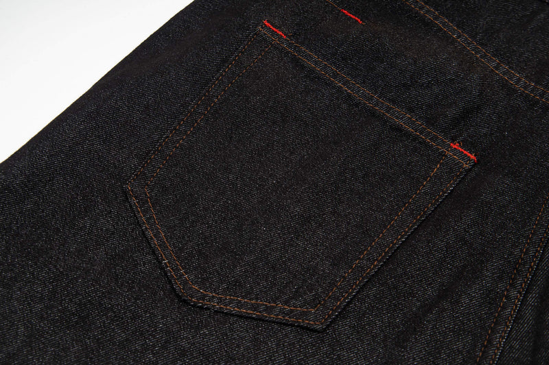 Close-up of dark wash denim back pocket with contrast stitching
