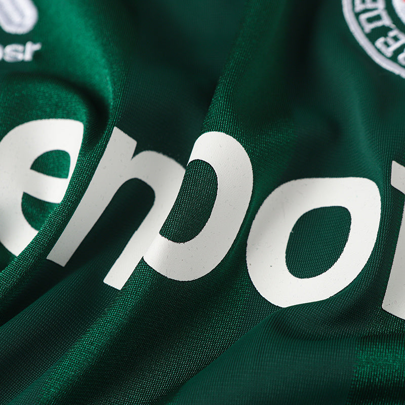 Close-up of a green Baenbofu soccer jersey with bold white logo lettering and textured performance fabric