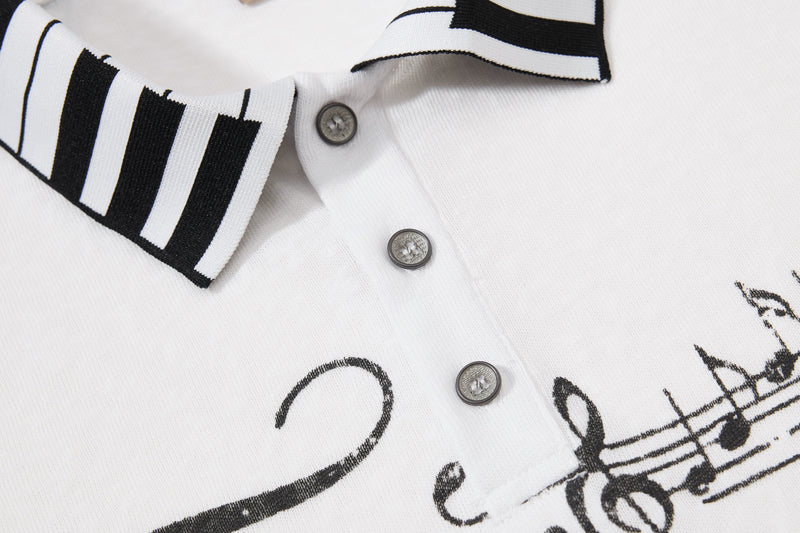White polo shirt with black striped collar and music note graphic print, close-up of buttons and fabric texture