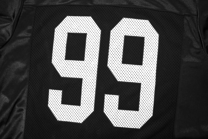 Close-up of black mesh jersey back showing the white 99 number