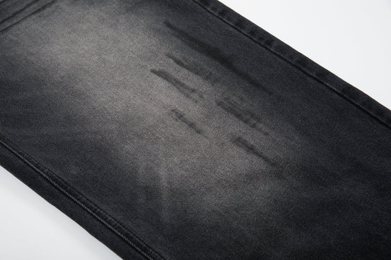 Close-up of wide-leg denim with faded crease marks and shadow wash effect