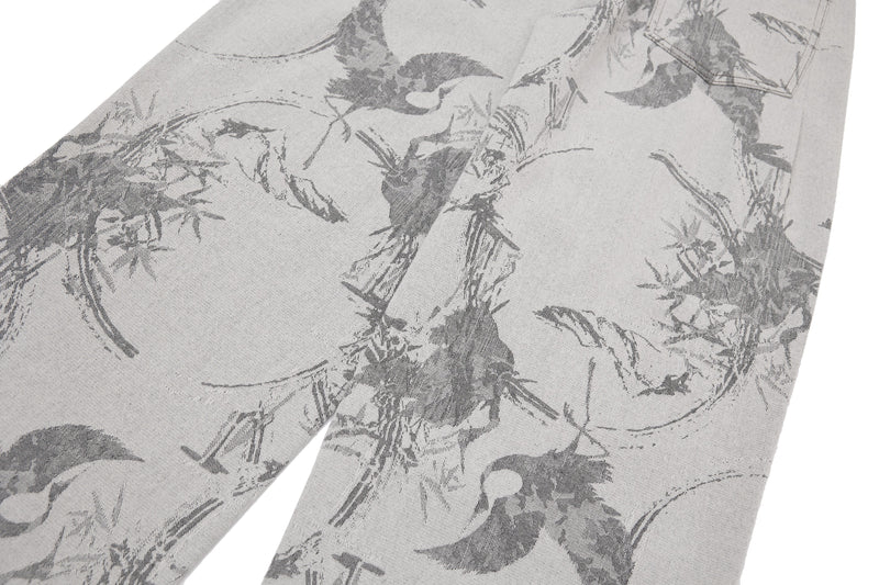Close-up of the front leg panels on gray wide-leg denim with abstract brushstrokes