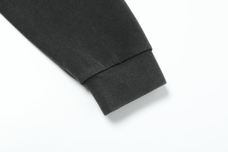 Black sleeve cuff close-up with ribbed knit hem