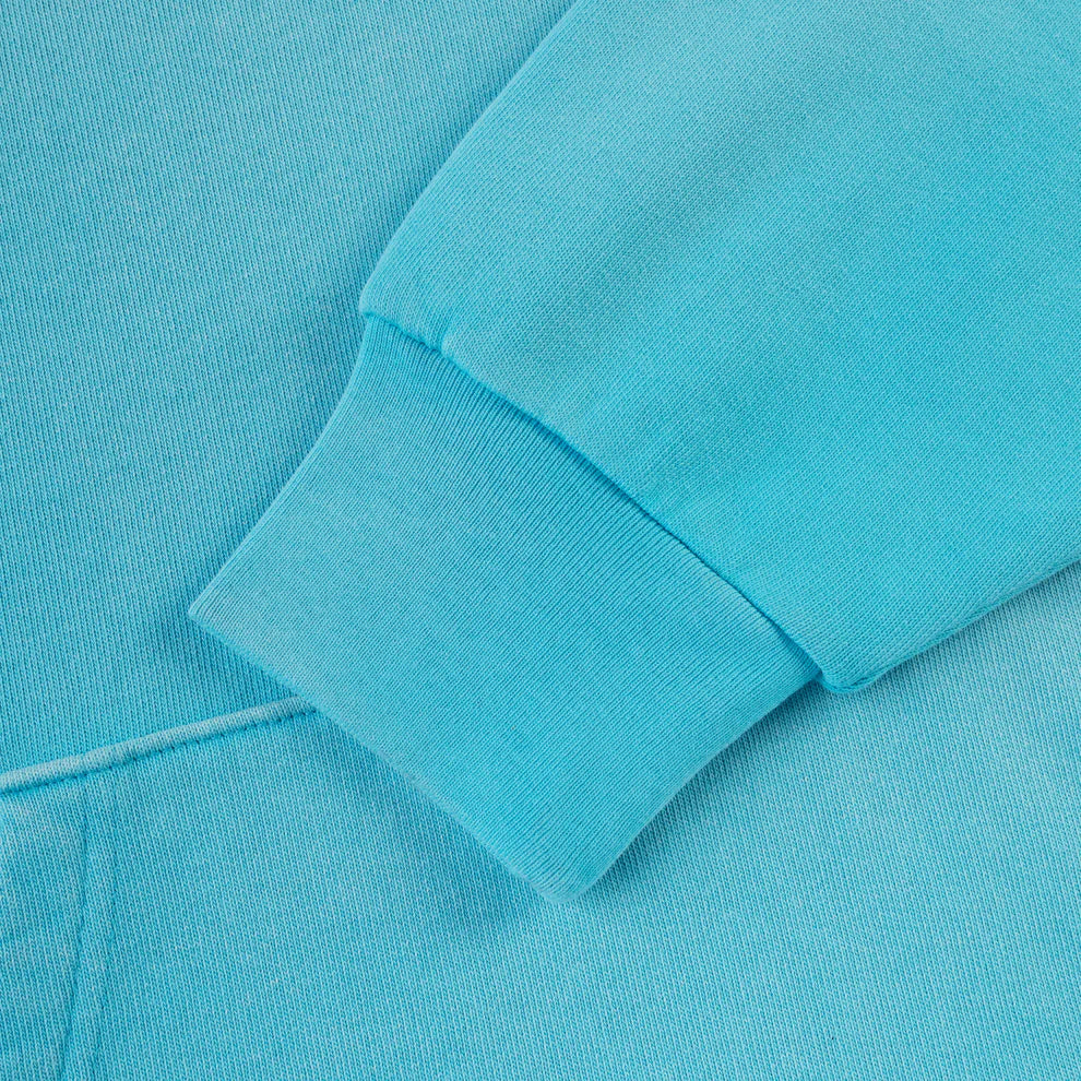 Close-up of the sleeve and cuff on the Turquoise Graphic Hoodie with Star Detail and Spider Web Back Print, showing ribbed texture, detailed stitching, and soft fabric of this comfort fit pullover hoodie.