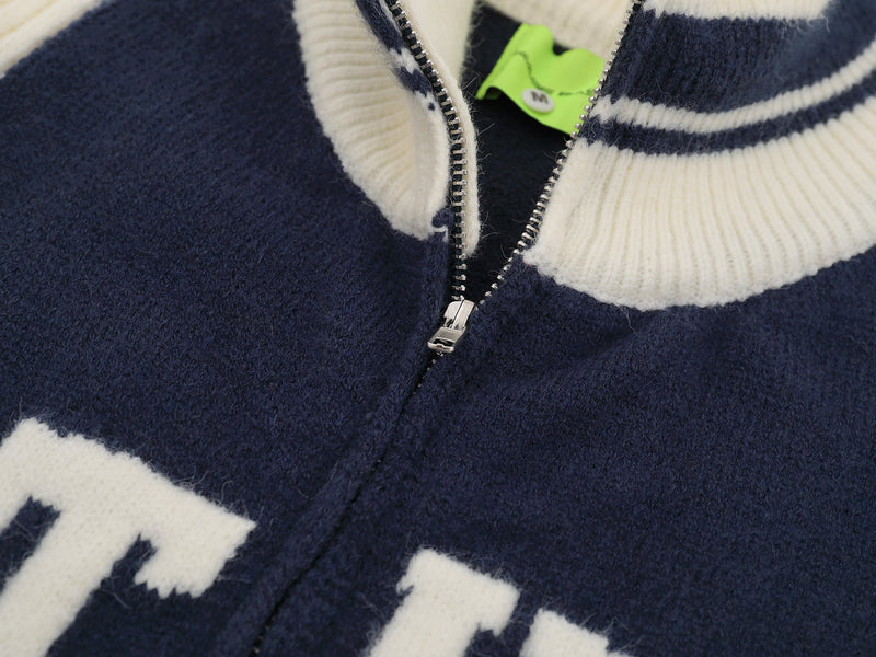 Close-up of navy and cream zip front with ribbed varsity collar