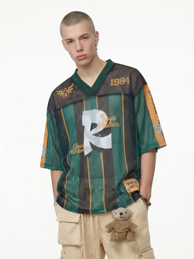 Model wearing a green and black mesh jersey T-shirt with Royal Madness 84 graphic and yellow accents