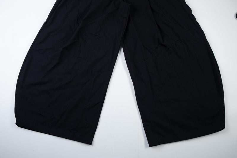 Black wide-leg cargo pants laid flat, lower legs and hem view