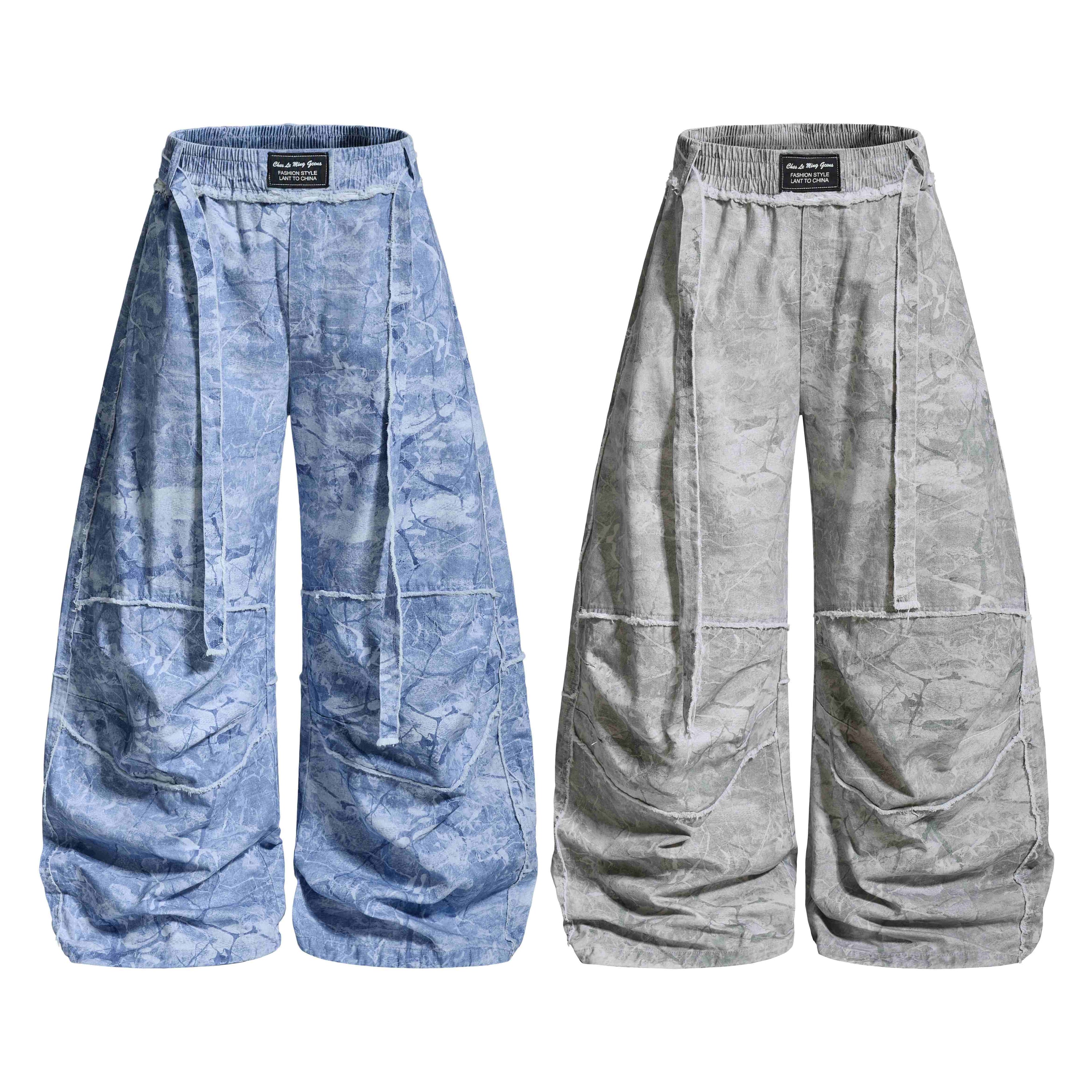 Omirad washed marble wide-leg baggy pants in faded blue and grey, front view, showing elastic waistband and panel stitch deta