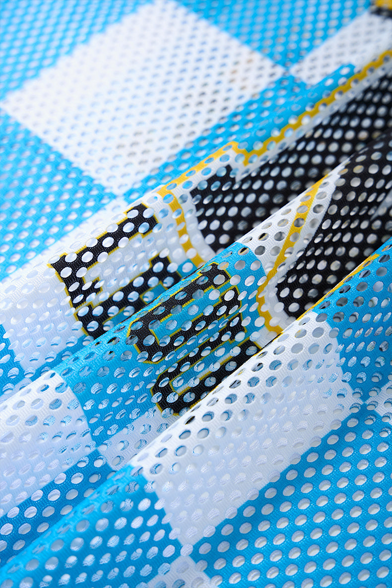 Close-up of blue, white, and black checkerboard mesh fabric on a Wild Cats N League jersey T-shirt