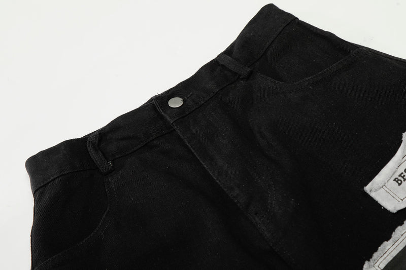 Close-up of black waistband with metal button and belt loop detail