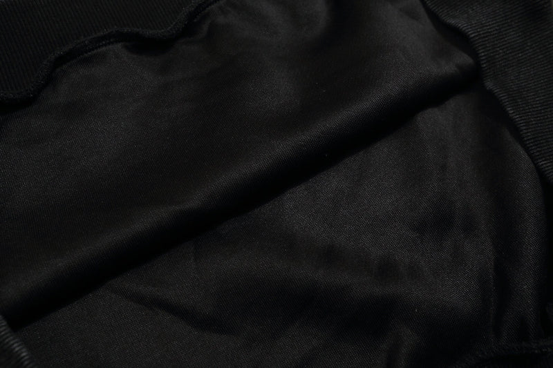 Close-up of black sweatshirt fabric texture with ribbed knit trim