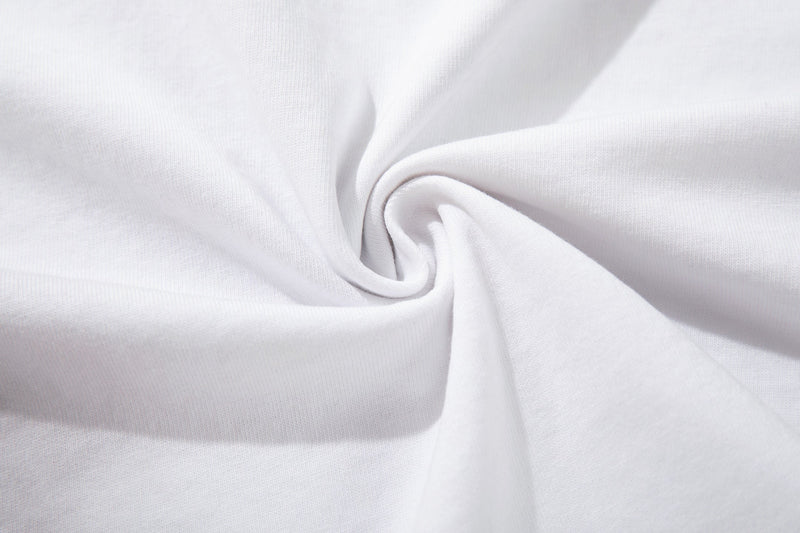 White oversized T-shirt fabric close-up with soft folded texture and smooth cotton knit surface