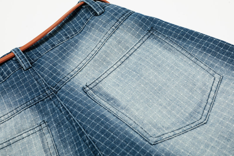 Rear close-up of back pocket and waistband on blue grid denim shorts