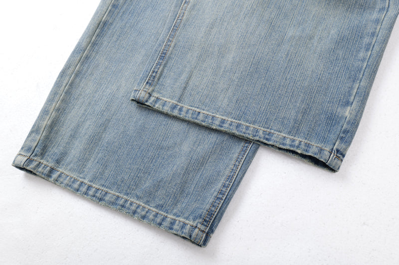 Close-up of wide-leg jean hems with faded blue wash and stitched cuffs