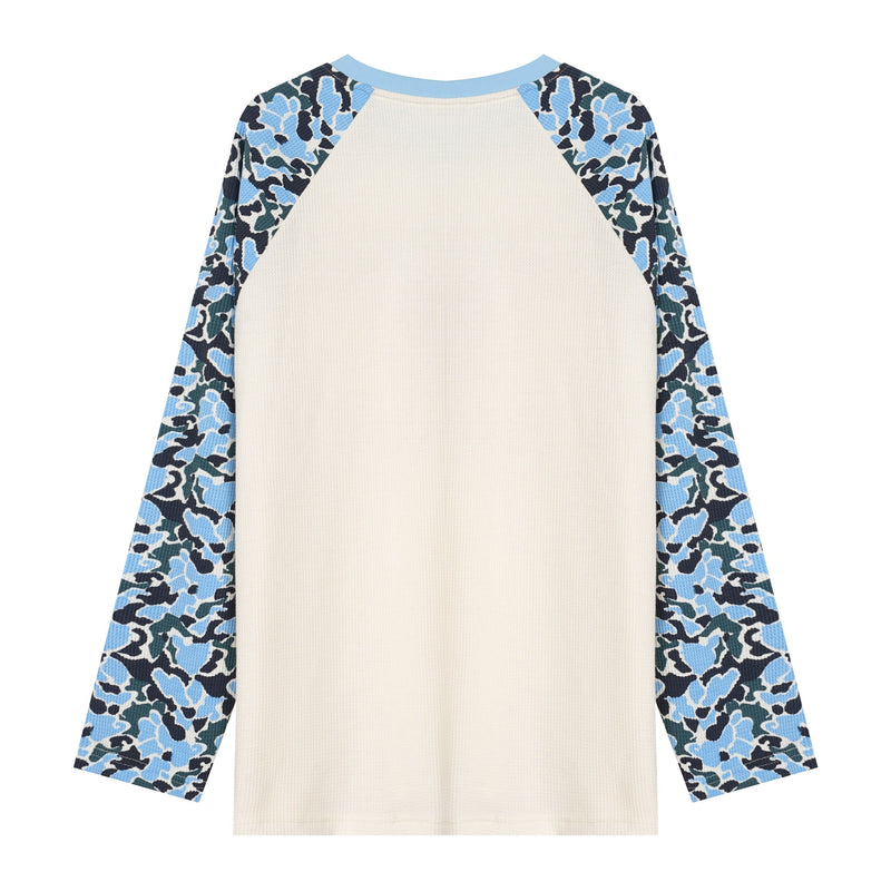 Front view of cream raglan long sleeve tee with blue camo sleeves and light blue ribbed crew neck