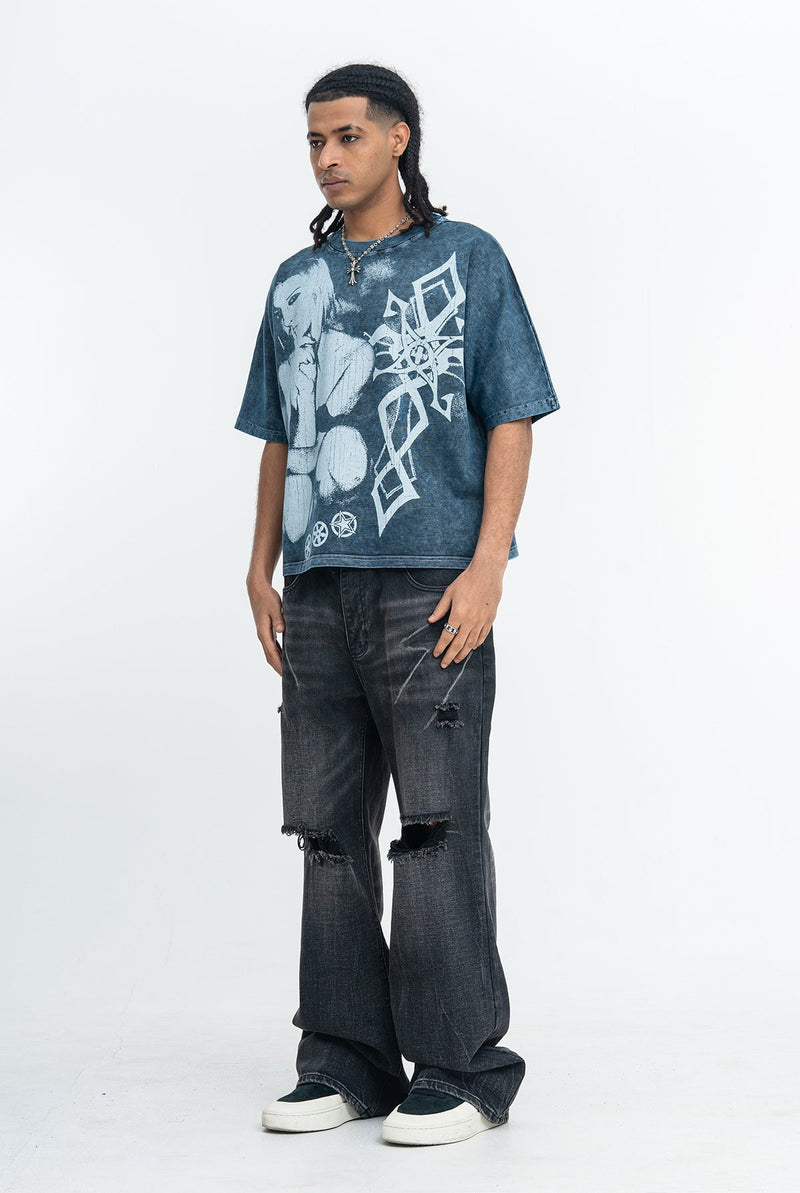 Vintage washed gothic graphic T-shirt in blue with oversized anime-style print, worn with ripped dark jeans and sneakers