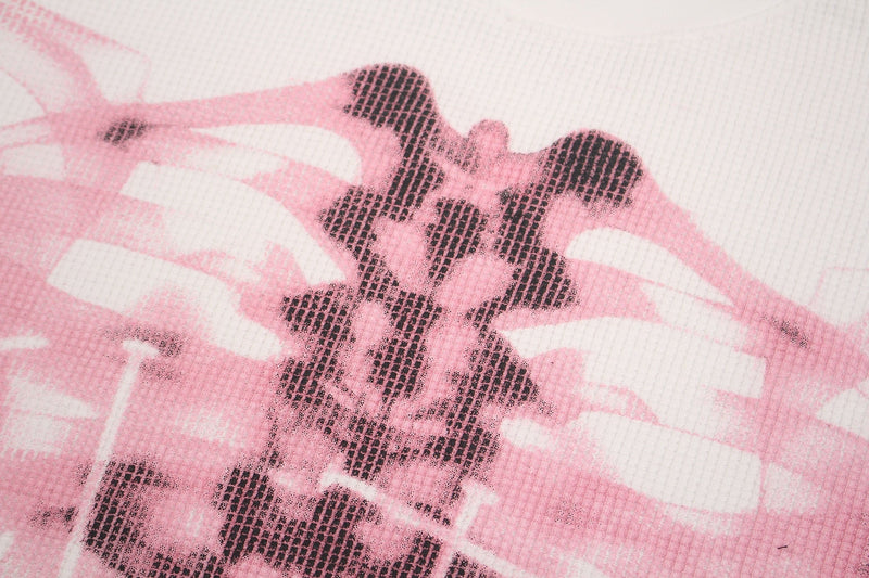 Close-up of a pink cyber-grunge graphic tee featuring a distressed black skeleton print on ribbed fabric