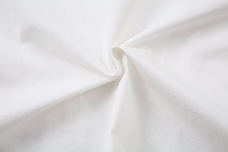 Close-up of plain white fabric texture and fold on the shirt