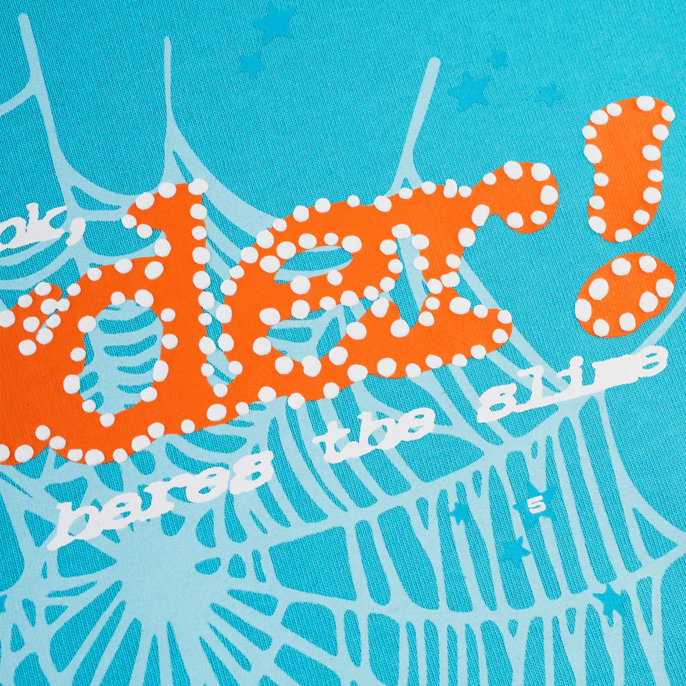 Close-up of bold orange and white polka dot text, inspired by streetwear and Sp5der “Nevermind the Spider” Hoodie – Sky Blue 440GSM, over a blue background with web-like designs and stars.