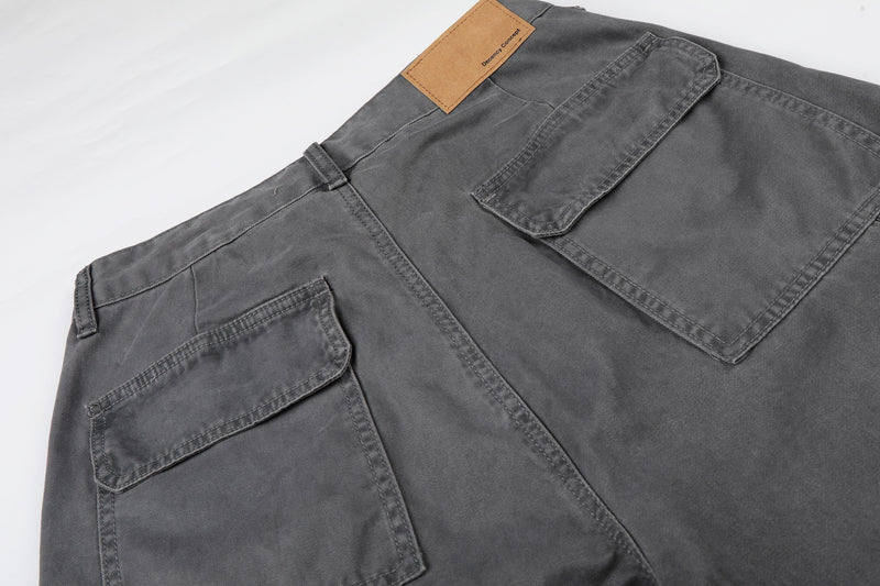 Close-up of gray shorts back pockets and tan waistband patch on the rear yoke