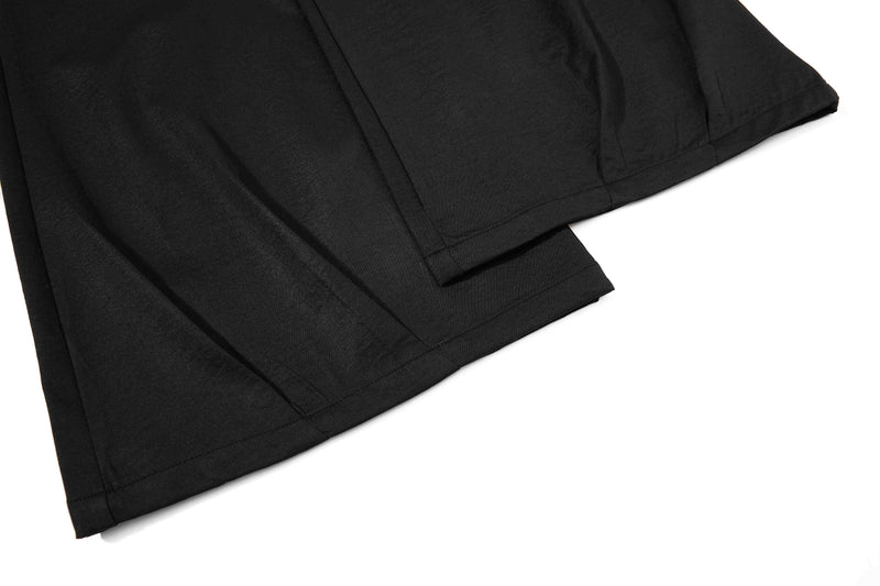 Close-up of black wide-leg pant hem with stitched seam and slight flare