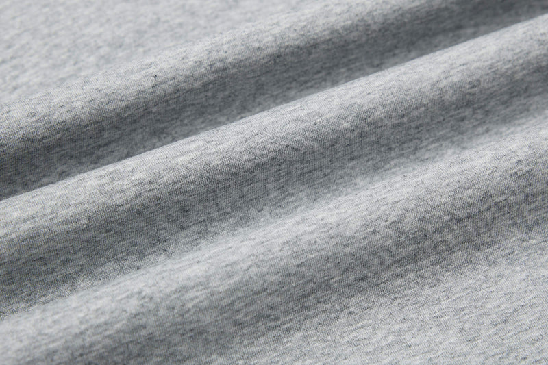 Close-up of heather gray knit fabric with soft folded texture, shown for a Seakoff knight attack graphic polo tee