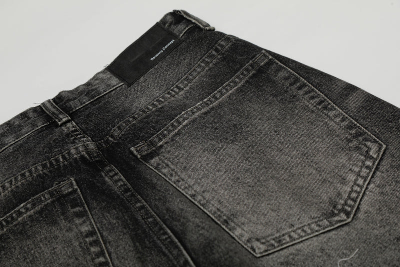 Close-up of back waistband and rear pocket on washed black wide-leg jeans