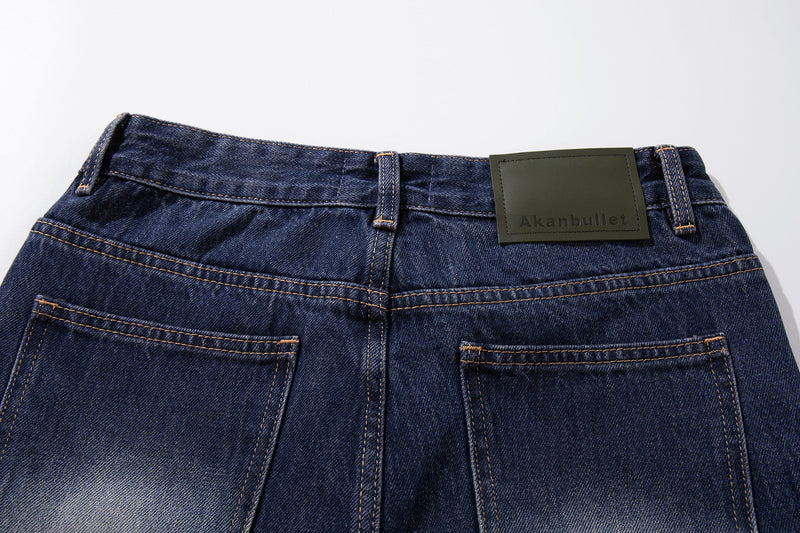 Close-up of the jeans back waistband with belt loops and green label patch